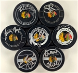 Chicago Blackhawks Signed Official NHL Game Puck Group of 16 Incl. Bobby Hull, Tony Esposito, Denis Savard and Others (BAS)