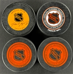 NHL Hall of Famers Signed Pucks (4) Incl. Gordie Howe, Bobby Hull, Phil Esposito and Bobby Hull (Beckett Authentic)
